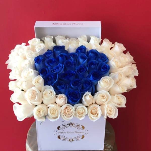 Heart-shaped bouquet of blue and white roses in a white box