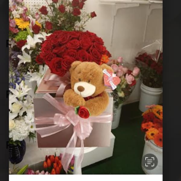 Red rose bouquet in a pink gift box with a teddy bear