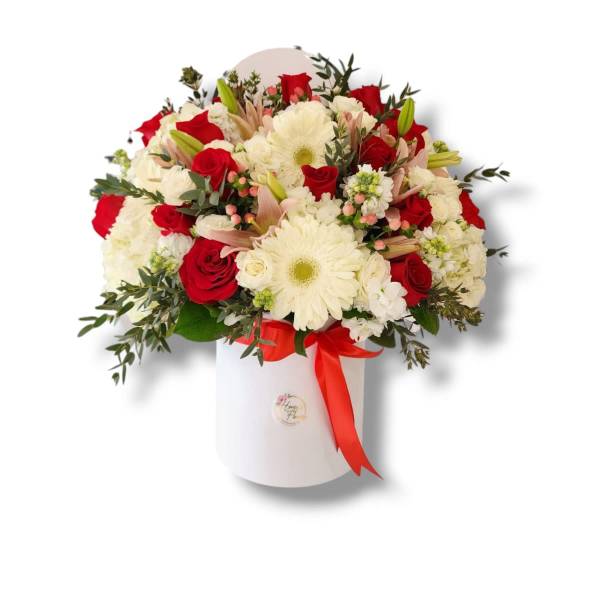 Red roses and white daisies in a white hatbox with a red ribbon