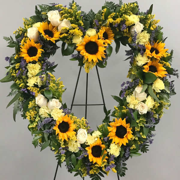 Heart-shaped floral wreath with sunflowers, white roses, and yellow blooms