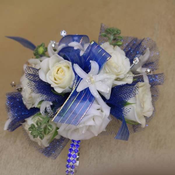 White roses with blue ribbon and mesh accents