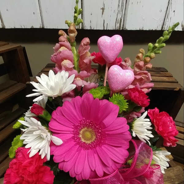 Pink gerbera bouquet with white daisies, carnations, and glitter heart picks