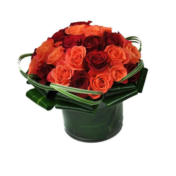 Bouquet of red and orange roses in a dark green container