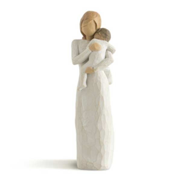 Carved figurine of an adult holding a child
