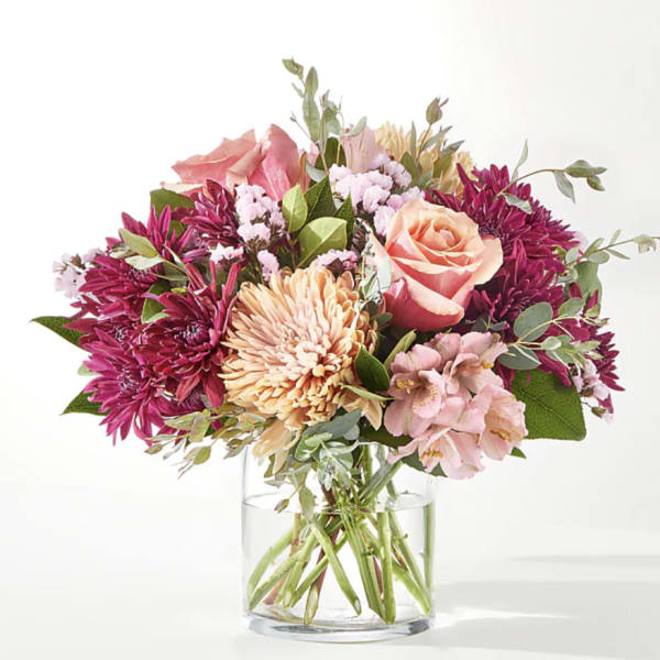 Pink and peach mixed bouquet in a clear glass vase