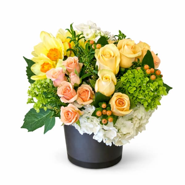 Mixed bouquet of yellow and peach roses in a black vase