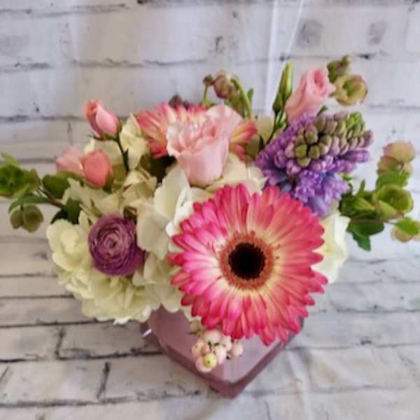 Pink and white mixed bouquet in a pink heart-shaped vase