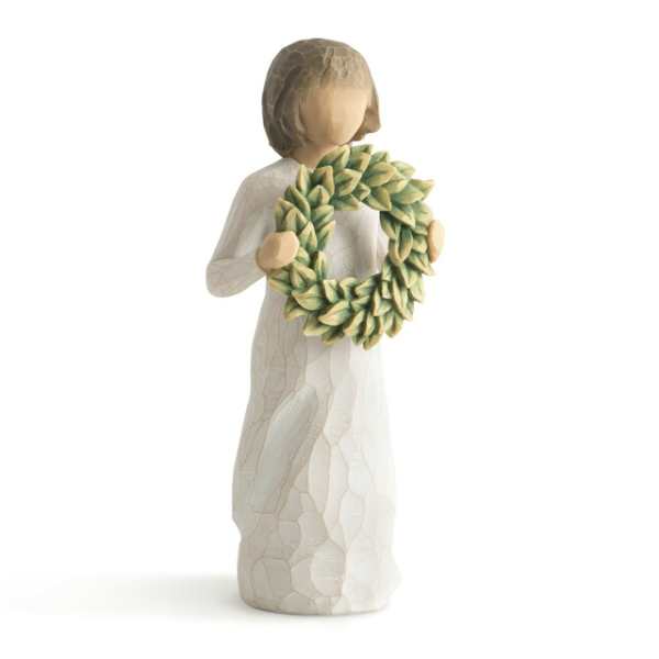 Figurine of an angel holding a green leaf wreath
