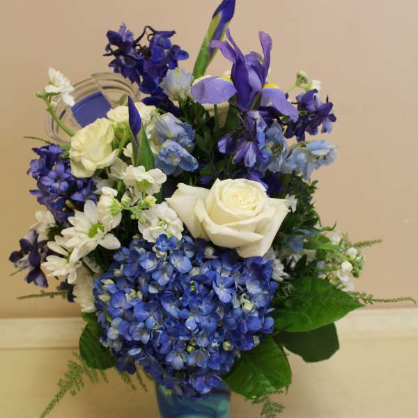 Blue and white floral arrangement in a patterned vase