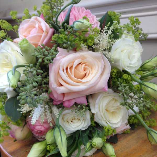 Bouquet of blush and white roses with green filler flowers