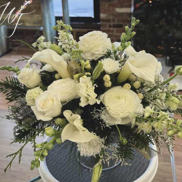 White floral arrangement with calla lilies and roses in a vase