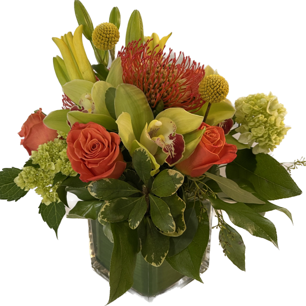Orange roses and green orchids in a clear glass vase