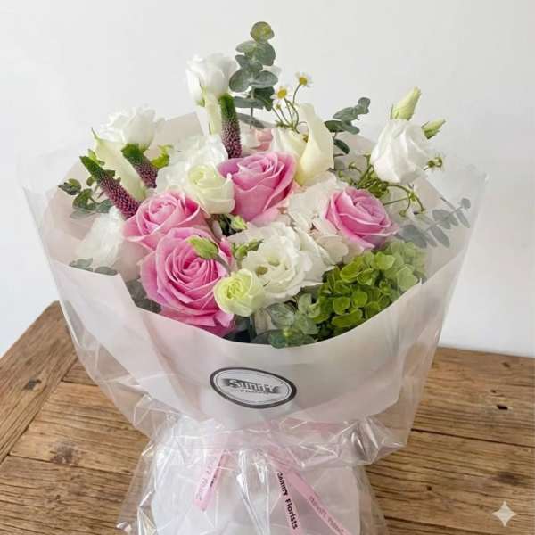 Bouquet of pink and white roses with calla lilies and eucalyptus