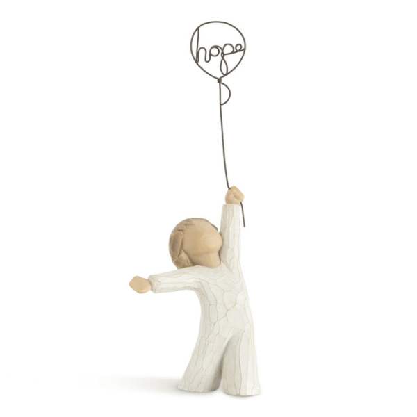 Small figurine holding a balloon with the word hope