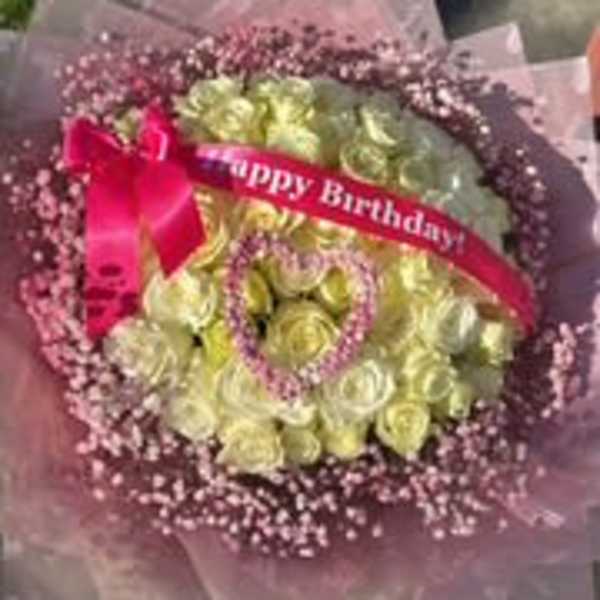 Pink and yellow rose bouquet with a birthday ribbon