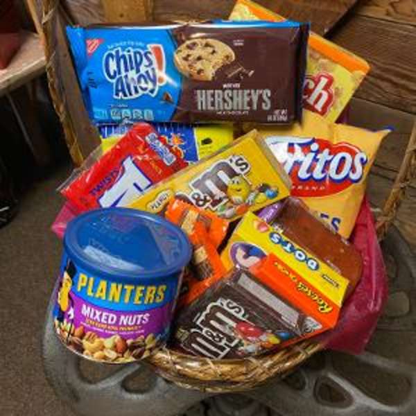 Basket filled with assorted candy bars and a can of mixed nuts