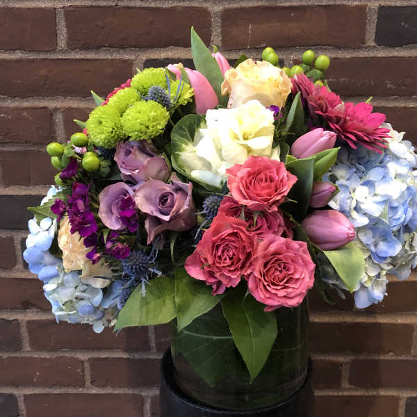 Mixed bouquet with roses, tulips, hydrangeas, and chrysanthemums in a vase