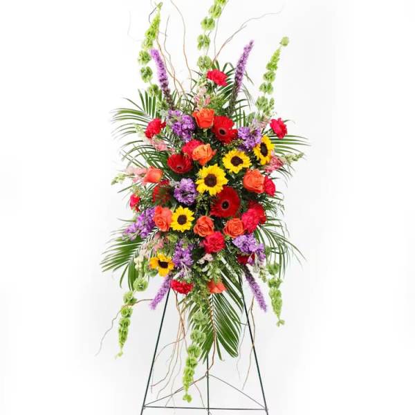 Tall standing floral spray with sunflowers, roses, and gerbera daisies