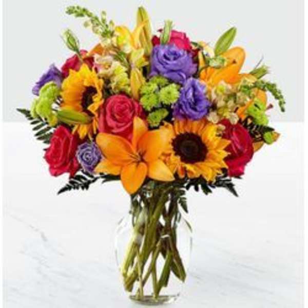 Colorful bouquet of mixed flowers in a clear glass vase