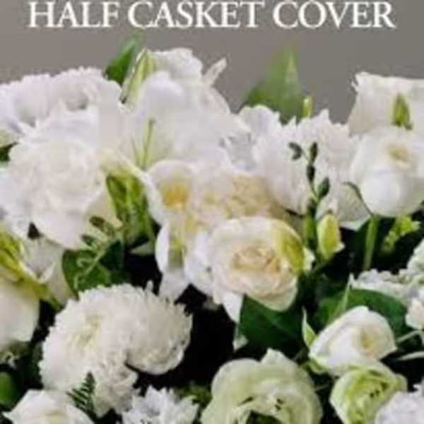 White floral casket cover with roses and lilies