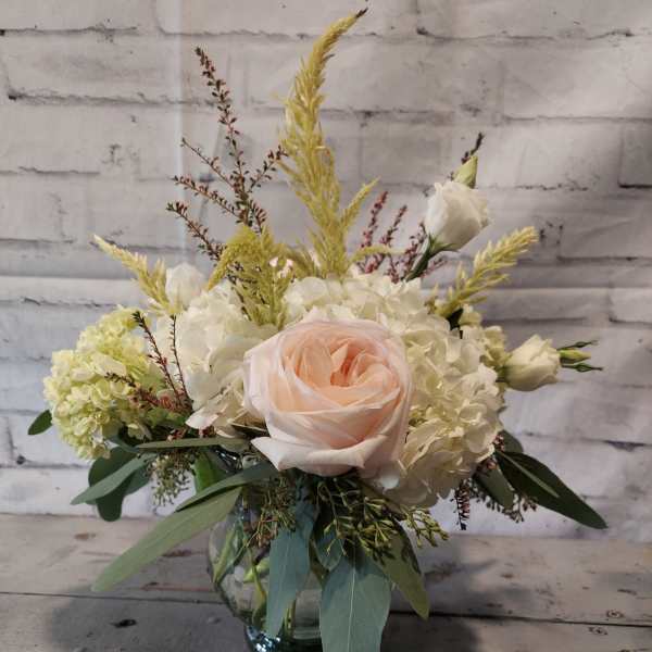Blush rose and white hydrangea arrangement in a glass vase