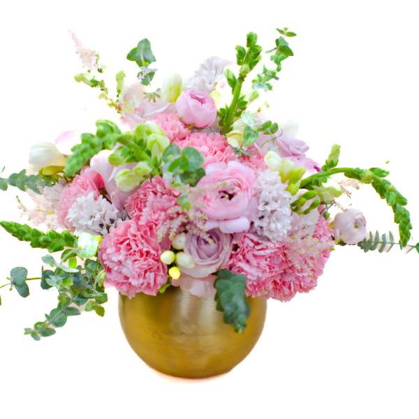 Pink and white floral arrangement in a gold vase