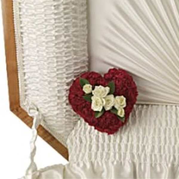 Heart-shaped floral arrangement with red and white flowers