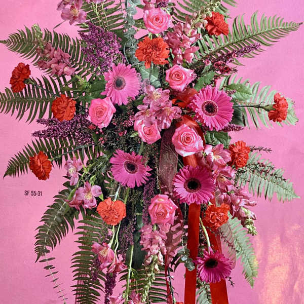 Pink and orange floral arrangement with gerbera daisies and roses