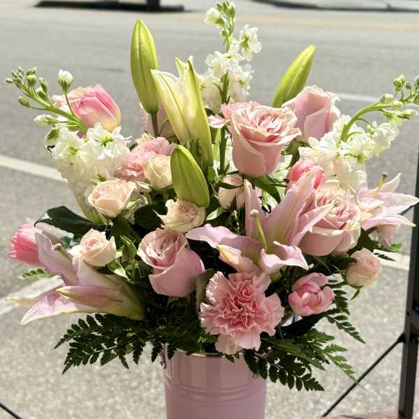 Pink and white bouquet in a tall pink vase