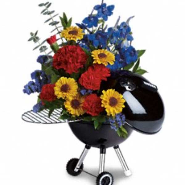 Colorful flower arrangement in a black kettle-style grill