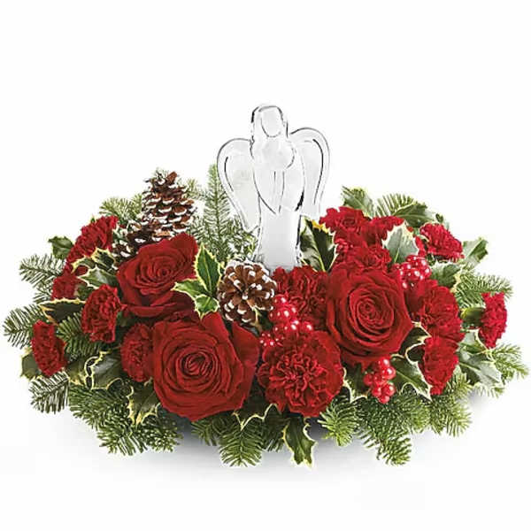 Red roses and carnations arranged with pinecones and an angel topper