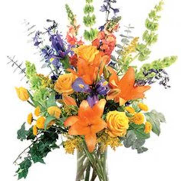 Orange and yellow mixed bouquet in a clear glass vase
