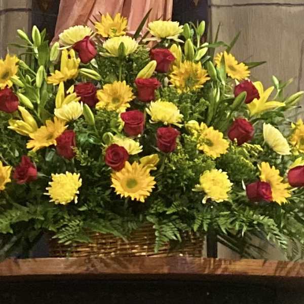 Large basket arrangement of red roses and yellow daisies