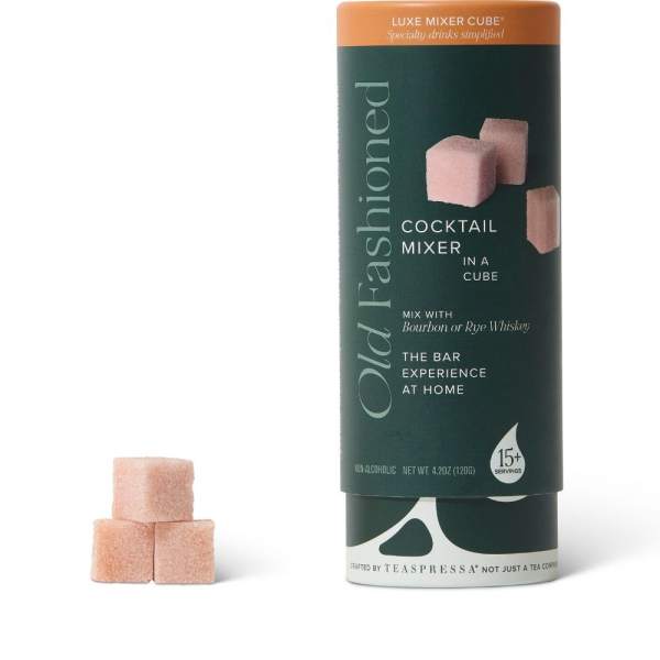 Cocktail mixer cubes in a cylindrical container with three cubes beside it