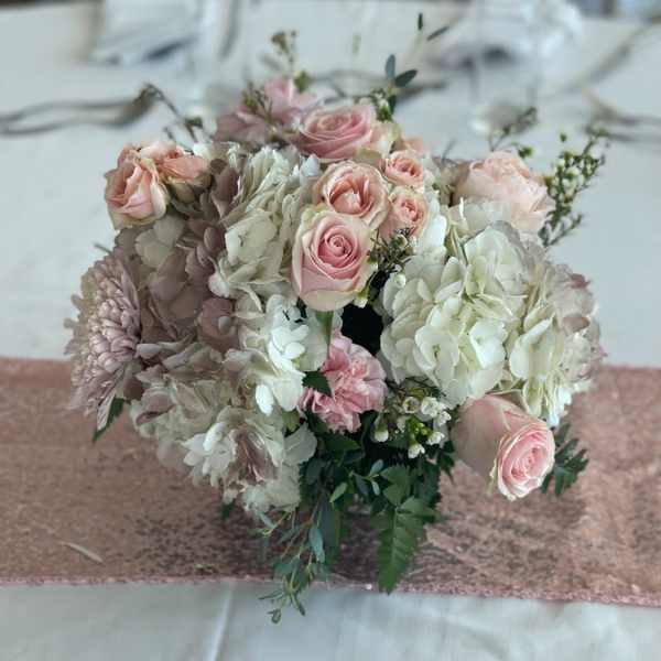 Blush roses and white hydrangeas arranged in a low bouquet