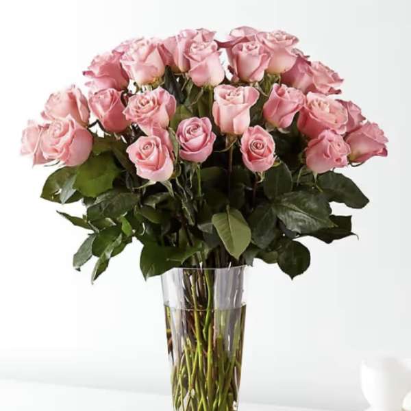 Pink roses arranged in a clear glass vase