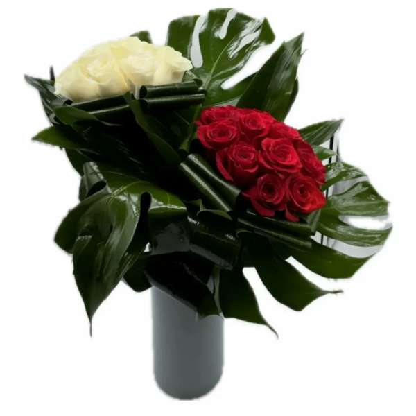 Red and white rose arrangement in a gray vase