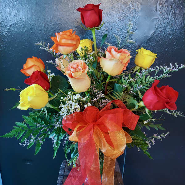 Bouquet of multicolored roses with an orange ribbon bow