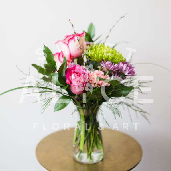 Pink and purple mixed bouquet in a clear glass vase
