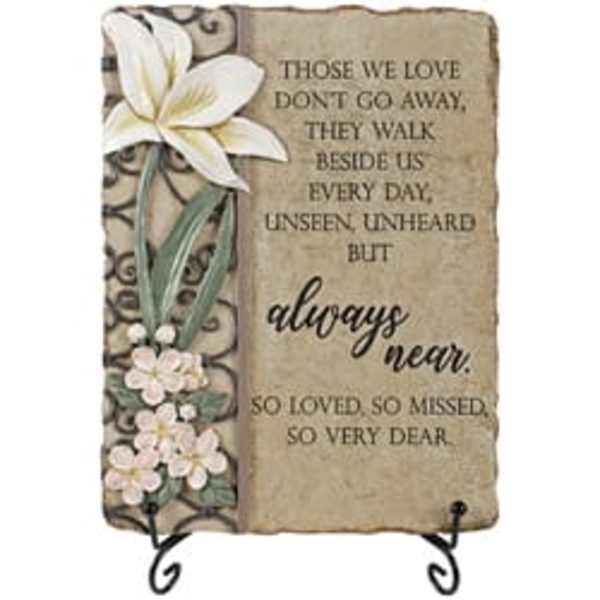 Decorative memorial plaque with white flowers and a sympathy quote