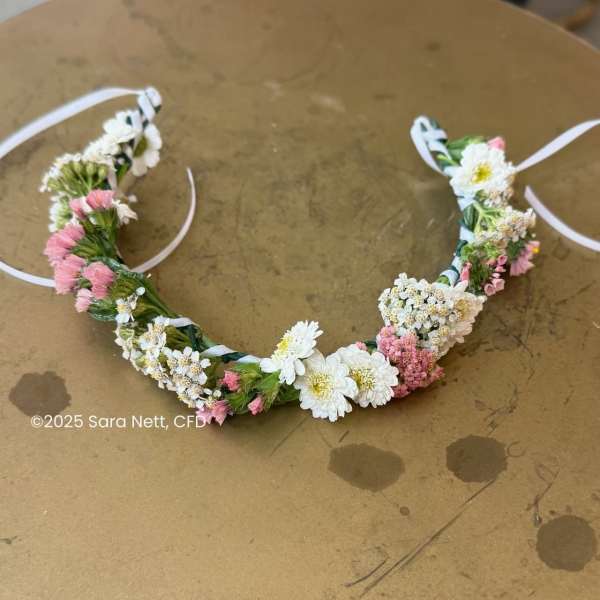 Floral crown with white and pink small flowers on a ribbon tie