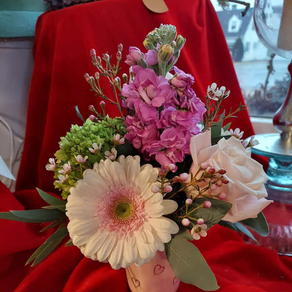 Pink and white mixed bouquet in a small heart-decorated vase
