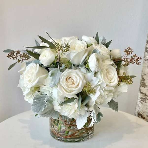 White rose bouquet in a clear glass vase