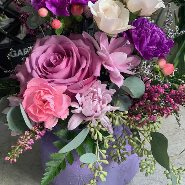Pink and purple mixed bouquet in a lavender vase