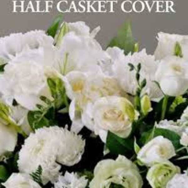 White floral half casket cover with lilies, roses, and carnations