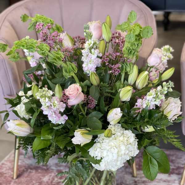 Mixed bouquet of pink and white flowers in a glass vase