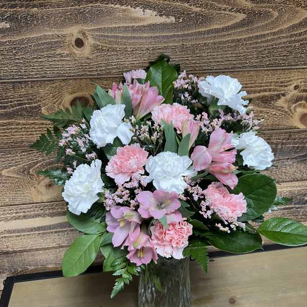 Pink and white bouquet in a glass vase