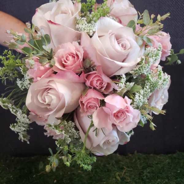Pink rose bouquet with white filler flowers and greenery