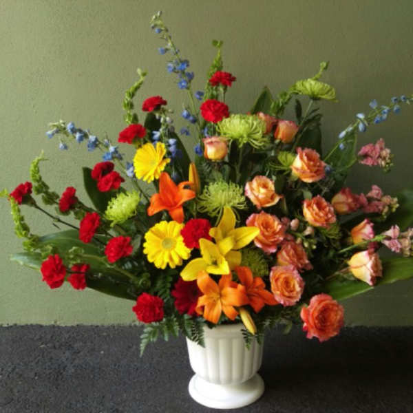 Colorful mixed flower arrangement in a white vase
