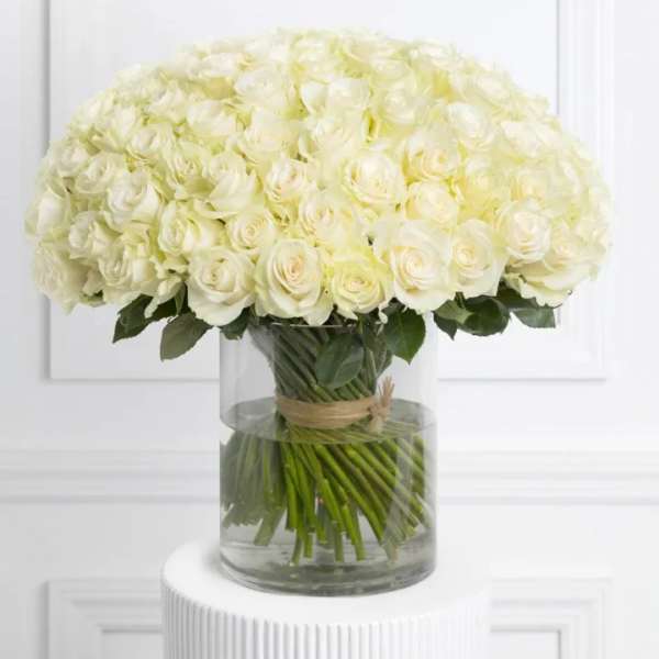 Large bouquet of white roses in a clear glass vase